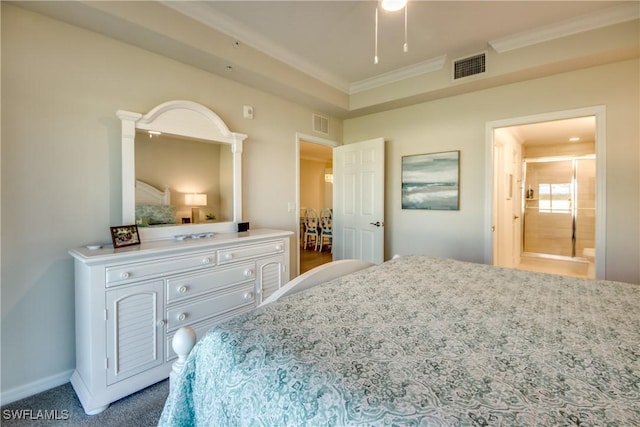 carpeted bedroom with ensuite bath and ornamental molding