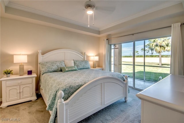 bedroom with ceiling fan, a tray ceiling, carpet flooring, and access to outside