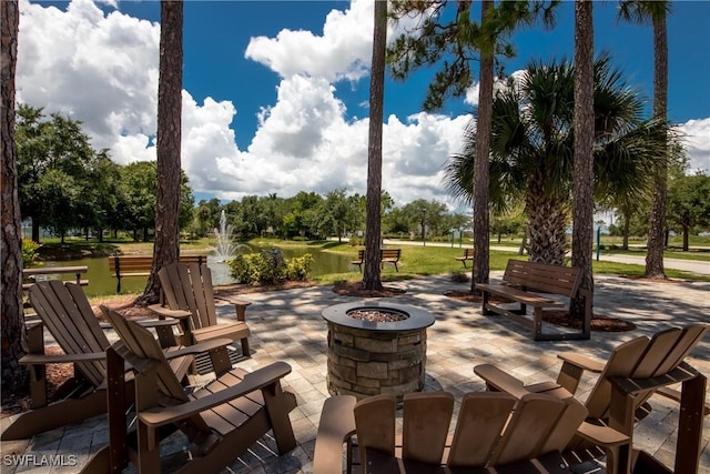 view of patio featuring a water view and an outdoor fire pit