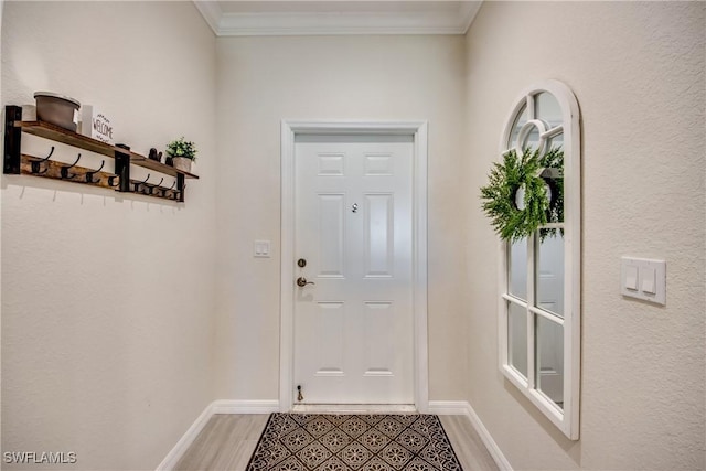 entryway featuring crown molding and light hardwood / wood-style flooring