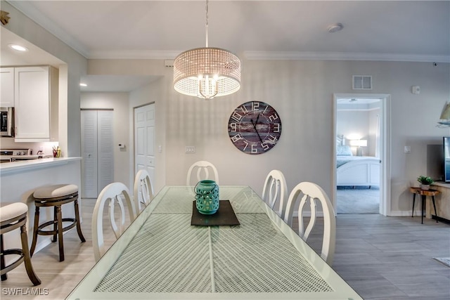 dining area featuring crown molding and a chandelier