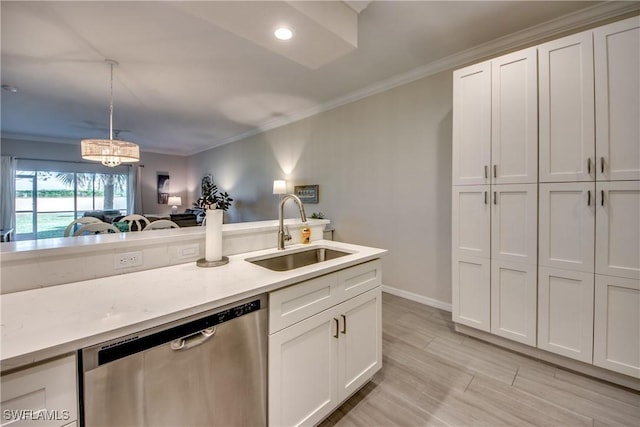 kitchen featuring pendant lighting, white cabinetry, sink, ornamental molding, and stainless steel dishwasher