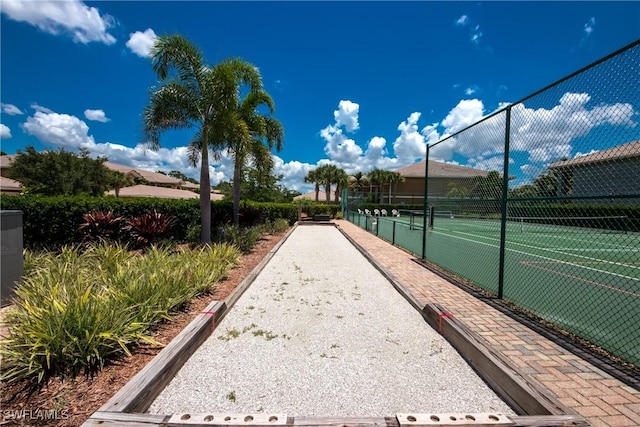 view of property's community featuring tennis court