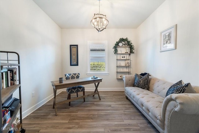 home office with a chandelier, wood finished floors, and baseboards