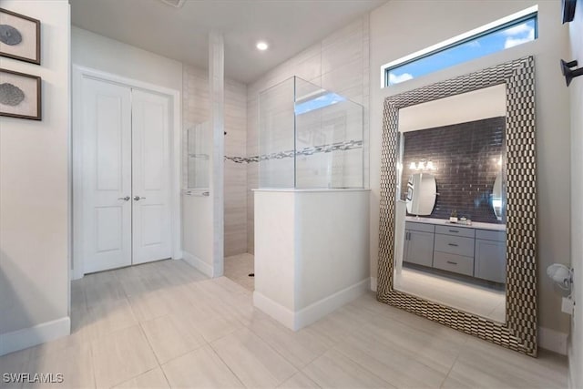 full bathroom with a walk in shower, recessed lighting, vanity, baseboards, and backsplash