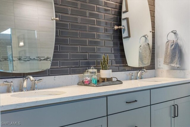 full bath with double vanity, a sink, and decorative backsplash