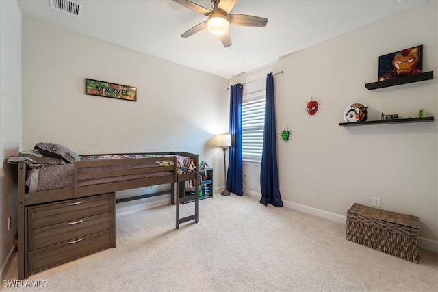 carpeted bedroom with a ceiling fan, visible vents, and baseboards