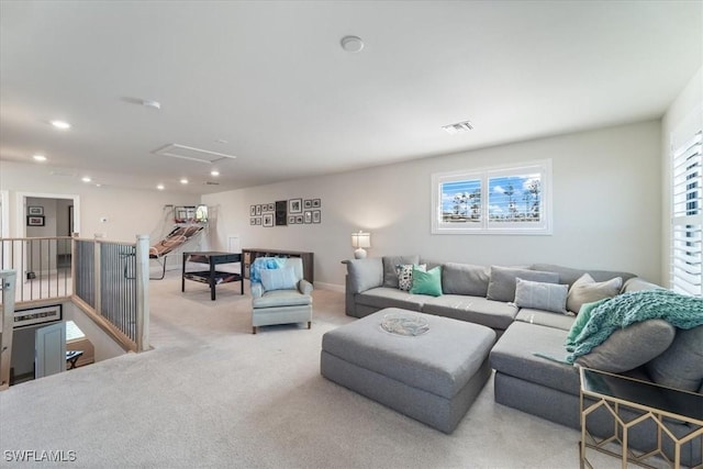 living area with recessed lighting, carpet, visible vents, and attic access