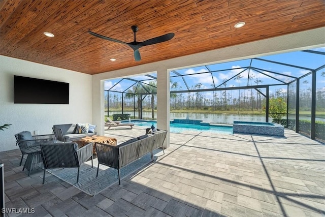 view of patio / terrace featuring ceiling fan, glass enclosure, a pool with connected hot tub, and an outdoor living space