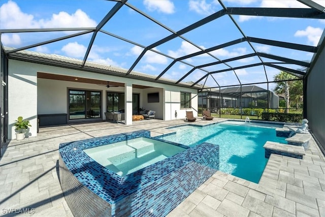 view of pool with a ceiling fan, a pool with connected hot tub, and a patio area