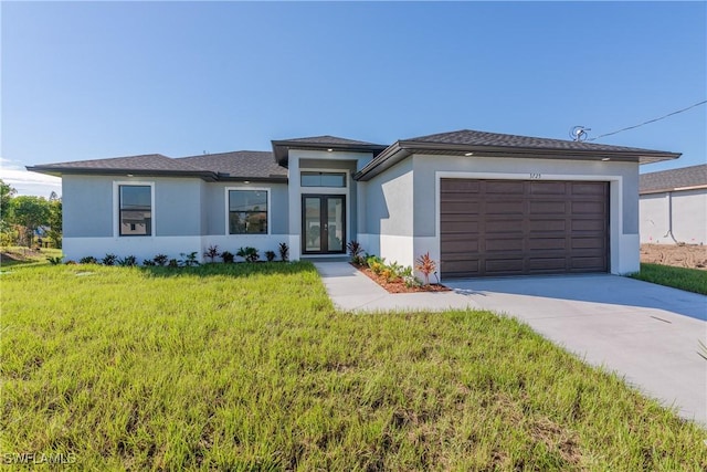 view of front of property with a garage, a front yard, and french doors