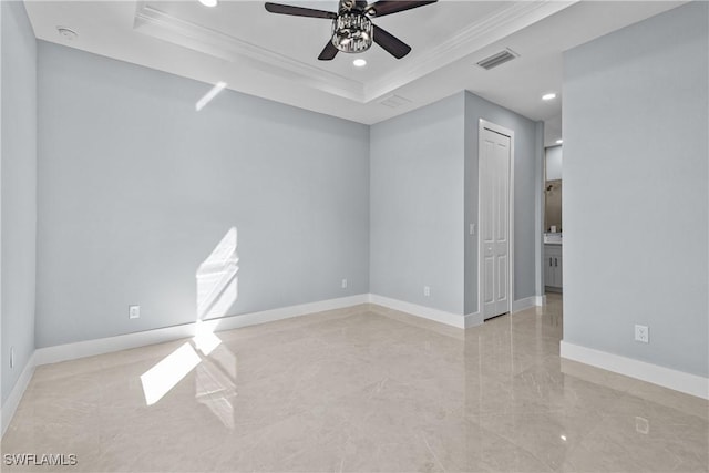 spare room with ornamental molding, a raised ceiling, and ceiling fan