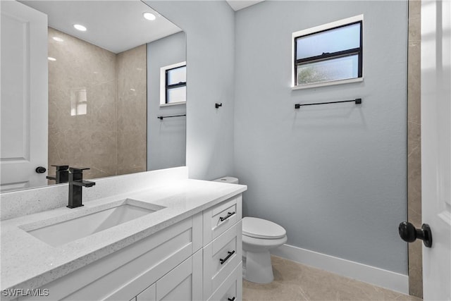 bathroom featuring vanity, toilet, and tile patterned flooring