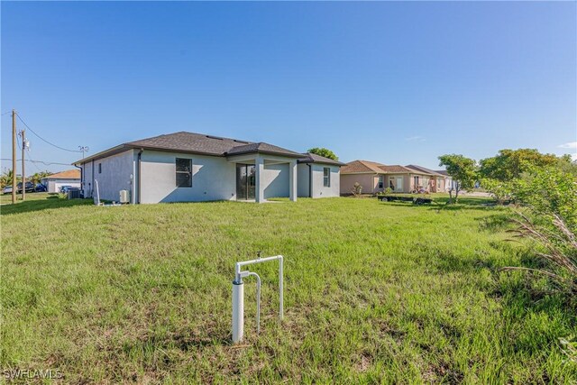 rear view of property with a lawn