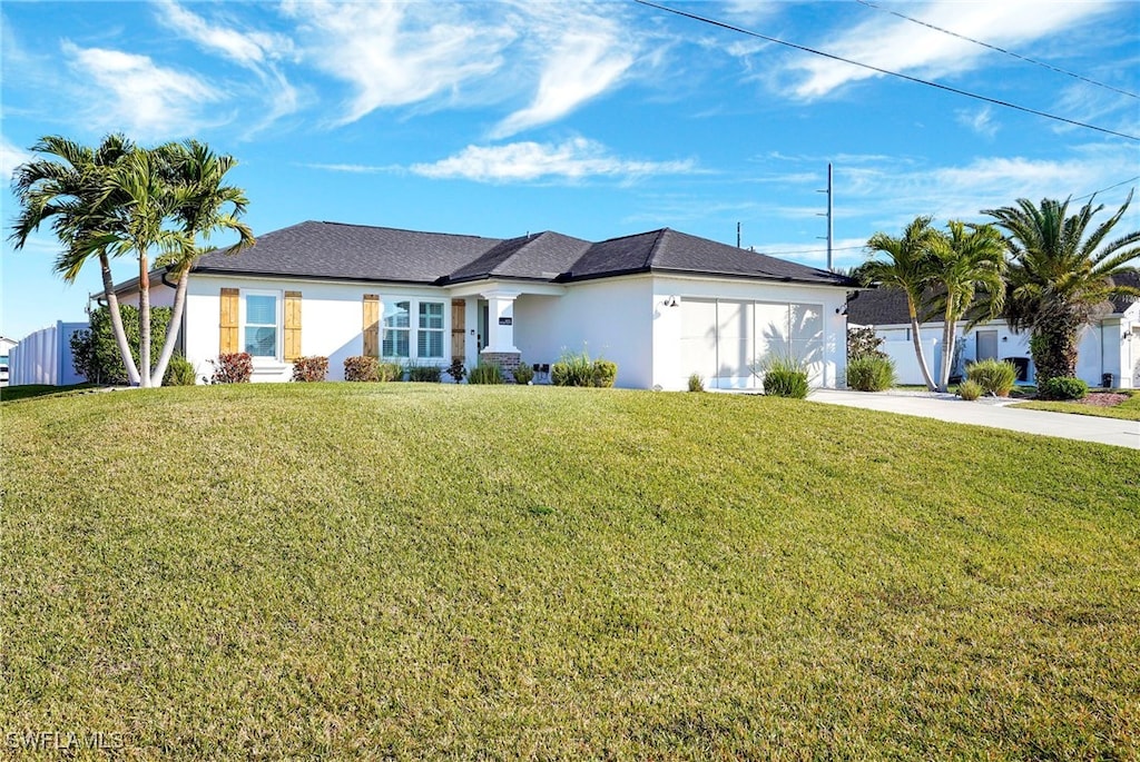 single story home with a garage and a front yard