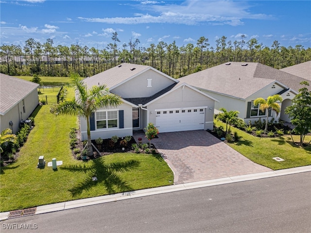 ranch-style house featuring cooling unit, a garage, and a front yard