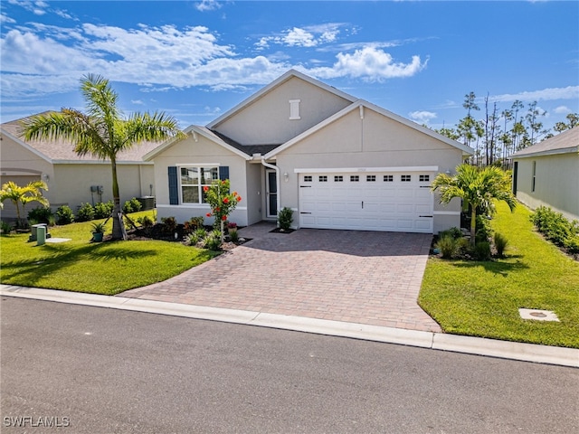 view of front of house with a garage, central AC, and a front lawn