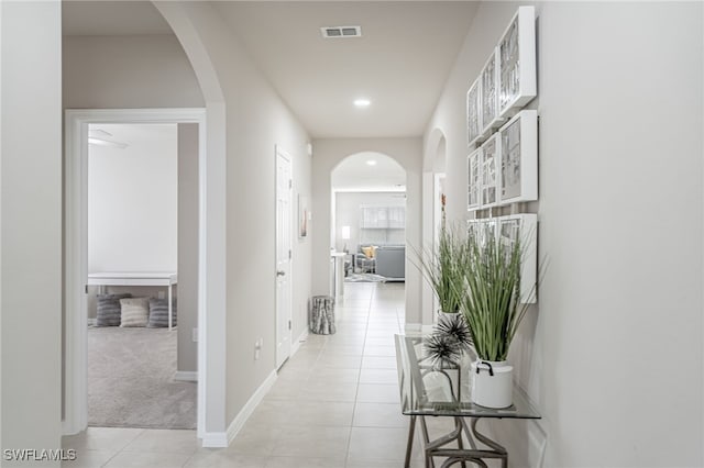 corridor featuring light tile patterned floors