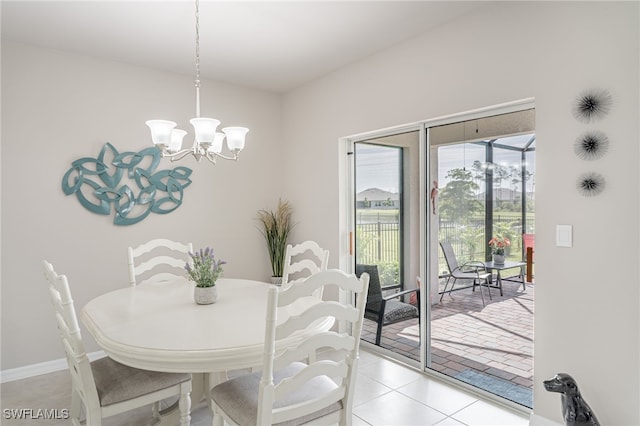 dining space featuring an inviting chandelier and light tile patterned floors