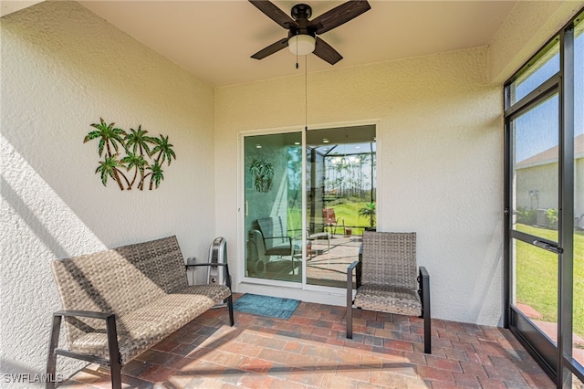 sunroom featuring ceiling fan