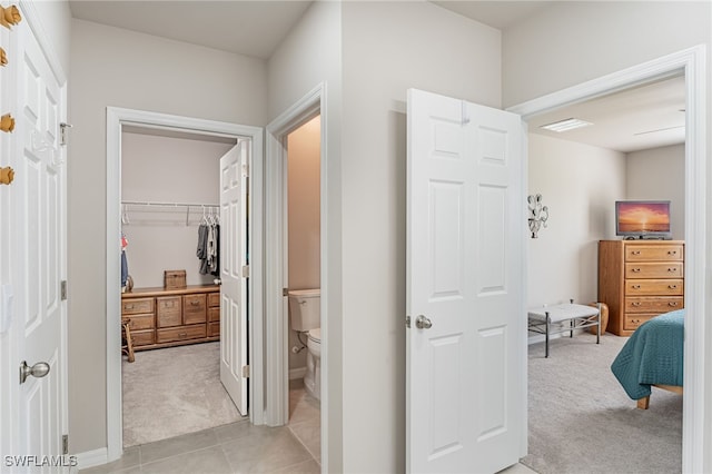 hallway featuring light colored carpet