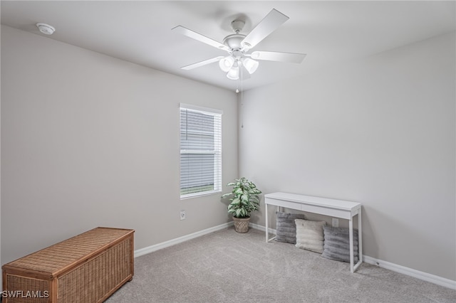 interior space featuring light colored carpet and ceiling fan