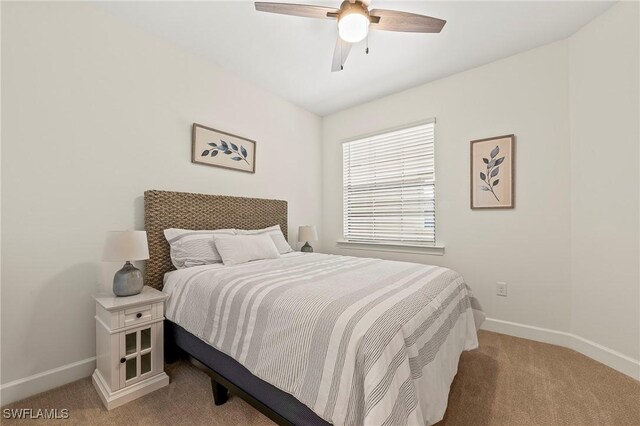 bedroom with light carpet and ceiling fan