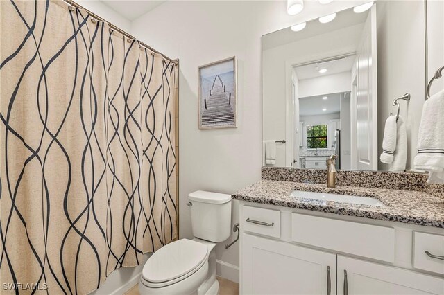 full bathroom featuring vanity, shower / bathtub combination with curtain, and toilet