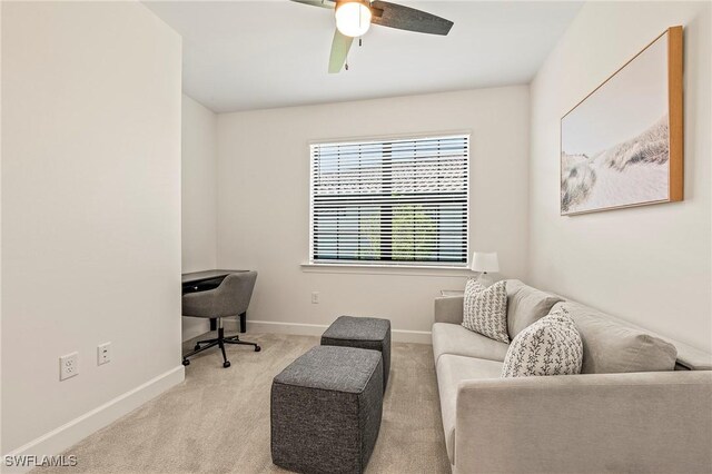 carpeted office space featuring ceiling fan