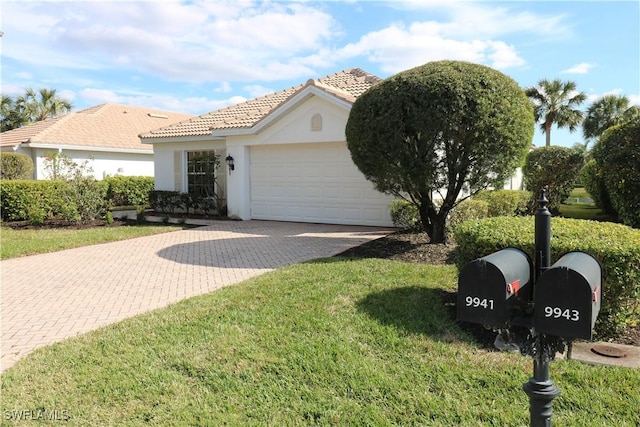 view of front of property featuring a garage and a front lawn