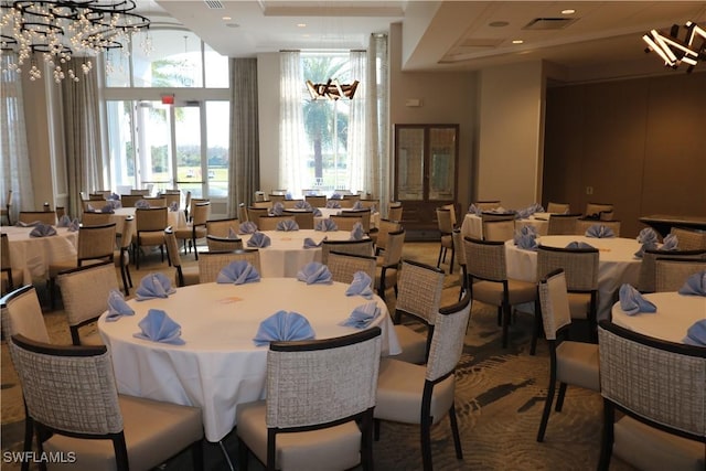 dining area with a towering ceiling