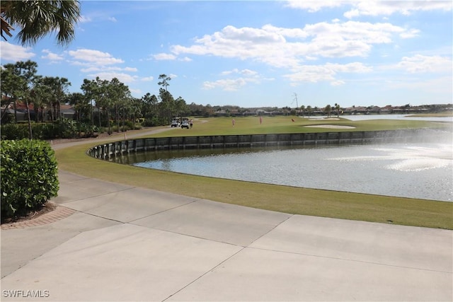 surrounding community featuring a water view and a yard