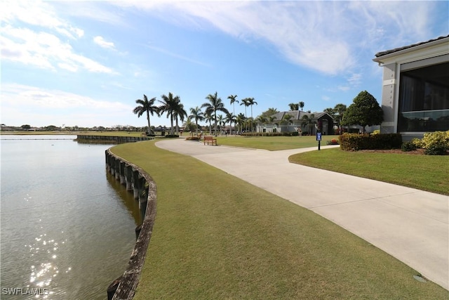 view of property's community featuring a water view and a lawn