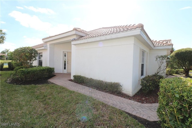 view of side of property with a yard