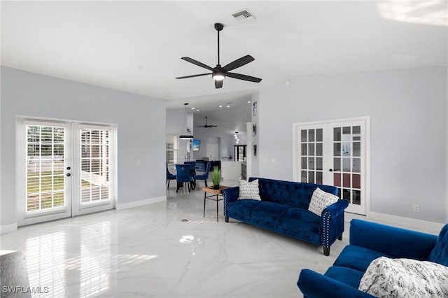 living room featuring ceiling fan and french doors