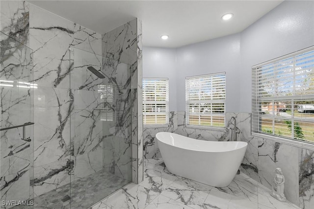 bathroom featuring shower with separate bathtub