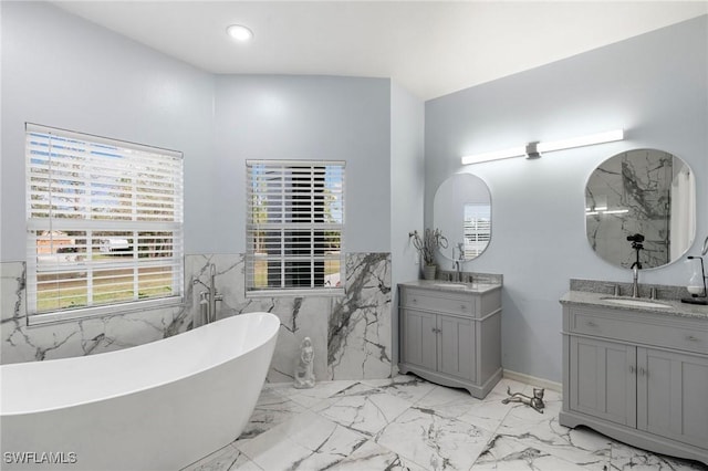 bathroom with vanity and a tub