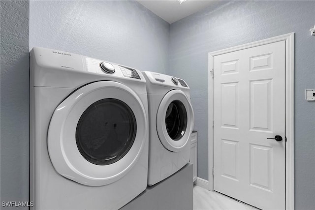 clothes washing area featuring washing machine and dryer