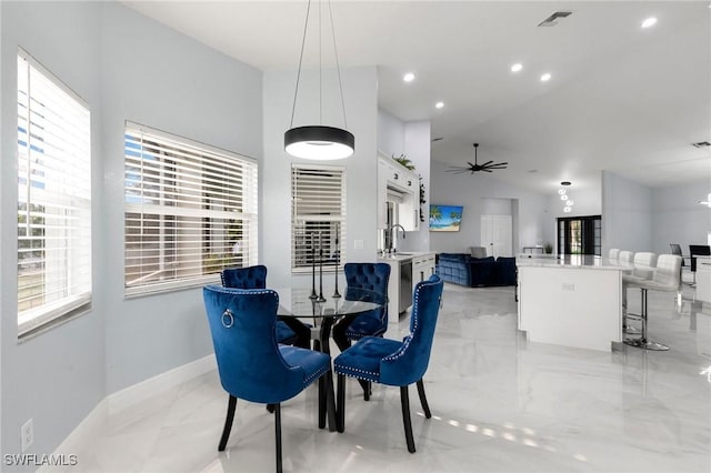 dining space with lofted ceiling, sink, and ceiling fan