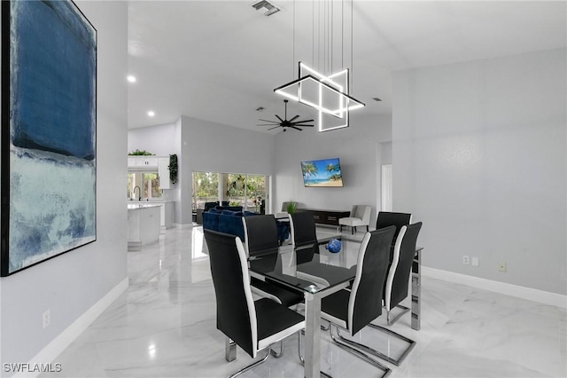 dining area featuring sink and ceiling fan