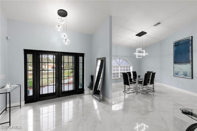 foyer entrance featuring an inviting chandelier and french doors