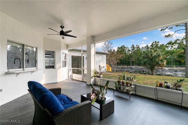 sunroom featuring ceiling fan