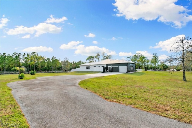 ranch-style home with a garage and a front lawn