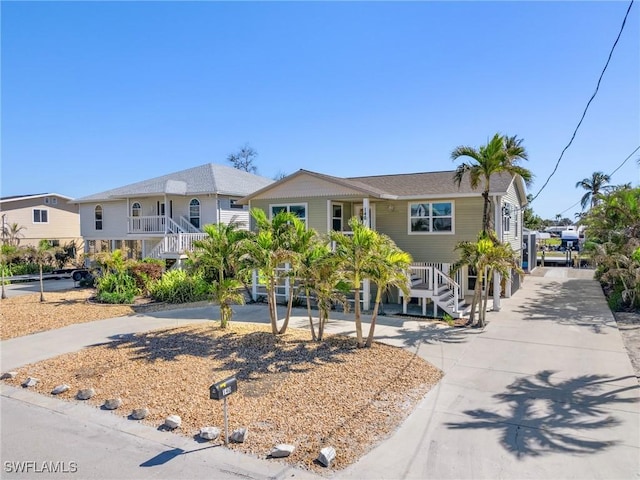 beach home featuring stairs and concrete driveway