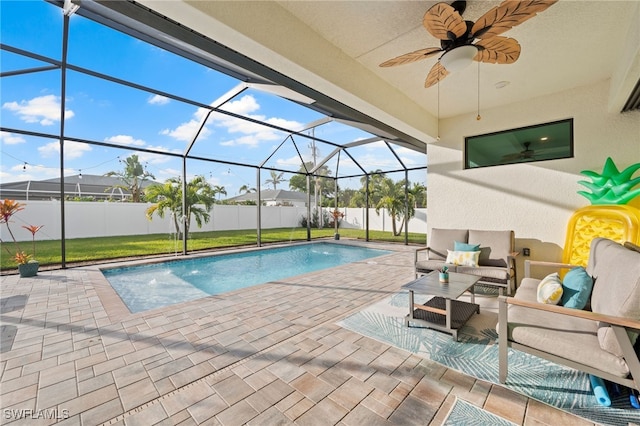 view of pool with pool water feature, outdoor lounge area, a lanai, and a patio