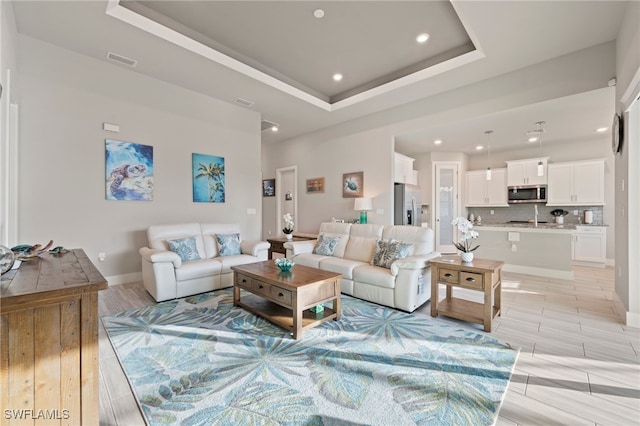 living room with a raised ceiling