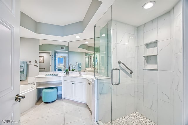 bathroom featuring vanity, shower with separate bathtub, and tile patterned flooring