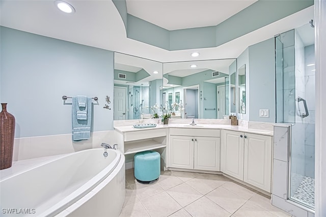 bathroom with tile patterned flooring, vanity, and separate shower and tub