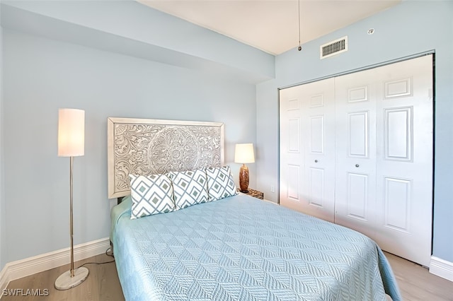 bedroom with light wood-type flooring and a closet