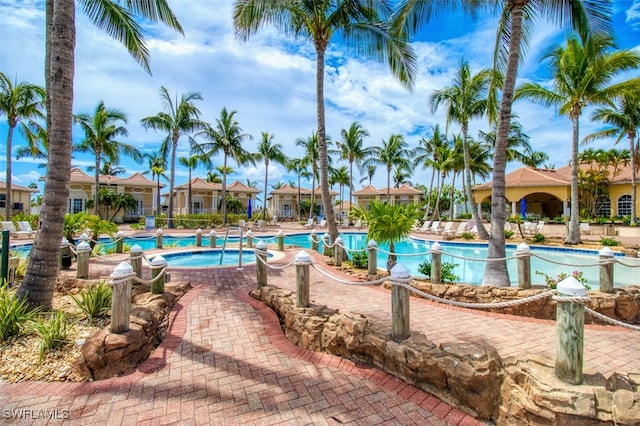 view of pool featuring a hot tub and a patio area